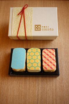 three different colored cookies in a box