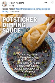 a person holding chopsticks over a bowl of dipping sauce