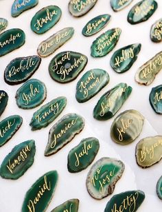 some green and gold sea shells with names on them for guests to sign in the sand