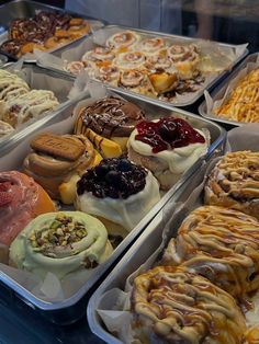 many different types of pastries in trays