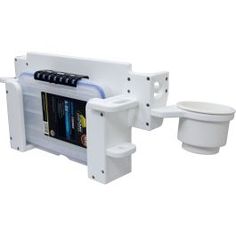 a white toilet sitting next to a wall mounted book shelf with magazine holders on it