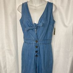 Take A Stand And Declare It. Boss Up And Step Out In This Strap Denim Jumpsuit That Is Sure To Lure Your Boo. It Features Front Buttons And A Tie-Up Top. This Romper Is A Comfortable Outfit That Can Be Worn With Heels Or High Top. Sleeve Style: Strap Size: Small Style: Denim Summer Cotton Denim Jumpsuit With Button-up, Blue Cotton Button-up Denim Jumpsuit, Casual Denim Jumpsuit With Buttons For Summer, Casual Buttoned Denim Jumpsuit For Summer, Blue Casual Button-up Jumpsuits And Rompers, Casual Blue Button-up Jumpsuit, Medium Wash Cotton Jumpsuits And Rompers With Buttons, Cotton Medium Wash Jumpsuits And Rompers With Buttons, Denim Overall Jumpsuit With Buttons For Summer