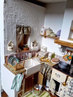 a kitchen with a sink, stove and other items on the counter top in it