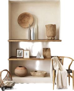 a shelf with baskets, vases and other items on it next to a chair