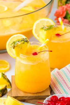 two glasses filled with lemonade and garnished with pineapple