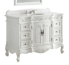 a white bathroom vanity with two sinks and drawers