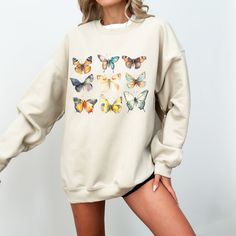 This vintage distressed  butterfly sweatshirt is a botanical and nature lover's new fave graphic crew. Head into spring with this cottagecore boho vibe.    For an oversized look, size up one or two sizes!   Every item is custom produced, made to order, so please note each item is unique and may differ in color slightly from photos, which is what makes every item special. If you have any issues, don't hesitate to reach out to us through messaging . We strive to make sure you're happy with what we Printed Relaxed Fit Sweatshirt For Fall, Casual Printed Relaxed Fit Sweatshirt, Spring Crew Neck Sweatshirt With Relaxed Fit, Spring Loungewear Sweatshirt With Comfortable Fit, Relaxed Fit Crew Neck Sweatshirt For Spring, Spring Sweatshirt With Relaxed Fit And Printed Details, Relaxed Fit Spring Sweatshirt, Bohemian Crew Neck Sweatshirt With Relaxed Fit, Spring Bohemian Cotton Sweatshirt