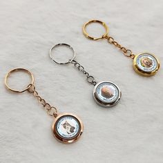 three key chains with two different types of keys attached to each other on a white surface