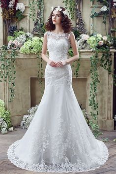 a woman standing in front of a fireplace wearing a wedding dress