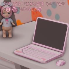 a pink laptop computer sitting on top of a desk next to a small stuffed animal