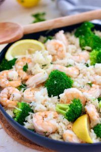 one pan shrimp and rice with broccoli in a blue bowl on a table