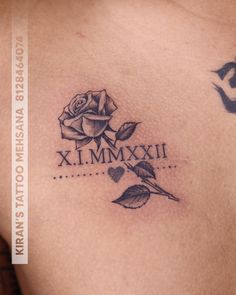 a rose tattoo on the back of a woman's shoulder that says x, mm, xi