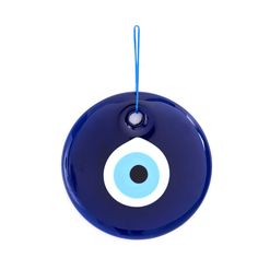 a blue evil eyeball ornament hanging from a string on a white background