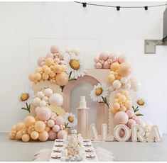 a table topped with cake and balloons next to a sign that says aurora on it