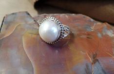 "White Pearl Ring Genuine Pearl Size 10 Can be re-sized at no additional cost Top: 17mm; 9/16\" Weight 5.9 grams Sterling Silver 925 Exclusively designed by Richard James for richlo jewelry Check out our other fine jewelry at https://www.etsy.com/shop/arizonagemstudio" Solitaire Pearl Ring In Sterling Silver, Silver Pearl Ring With Gemstone In Round Cut, Silver Pearl Ring With Round Cut Gemstone, Classic Silver Round-cut Pearl Ring, White Sterling Silver Hallmarked Pearl Ring, Richard James, White Pearl Ring, Silver Pearl Ring, Pearl Jewelry Gift