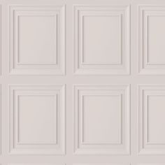 a white wall with many square panels on it