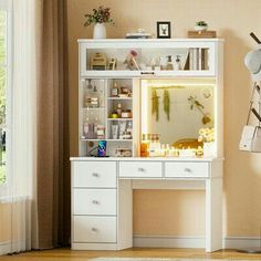 a white desk with a mirror and lights on it in front of a large window