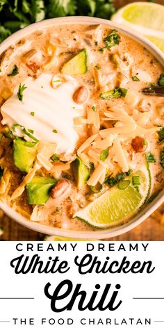 creamy white chicken chili with avocado, cilantro and sour cream in a bowl