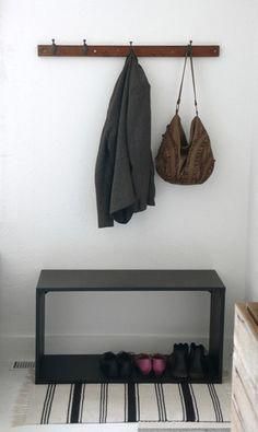 a bench and coat rack in a room