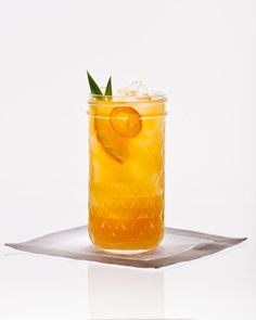 a glass filled with orange juice and garnished with an orange slice on top