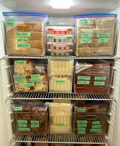 an open refrigerator filled with lots of food and plastic containers full of ice cubes