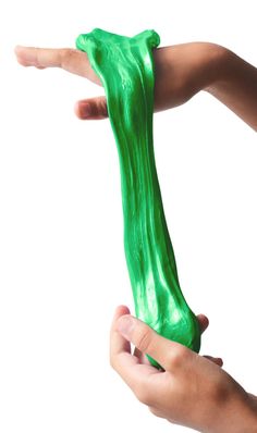 two hands holding a green object in the air