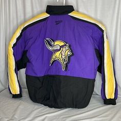 Color: Black with Purple, Yellow & White. Throwback Winter Track Jacket For Sports, 90s Style Long Sleeve Outerwear For Sports Events, Throwback Sports Track Jacket, Throwback Windbreaker For Winter Sports, Throwback Winter Sports Windbreaker, 90s Winter Sports Outerwear, Winter Sports Throwback Windbreaker, 90s Winter Outerwear For Sports Events, Vintage Minnesota