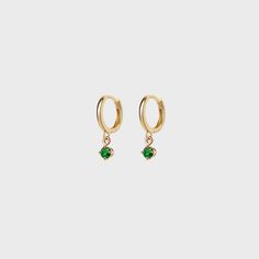 Elevate your style with our new gemstone round charm earrings. Create the perfect stack with our charm hoop collection. Green 14k Gold Hoop Earrings, May Birthstone Huggie Earrings, Elegant Green 14k Gold Huggie Earrings, Everyday Green Huggie Earrings, Yellow Gold Emerald Huggie Jewelry, Green Small Hoop Huggie Earrings Fine Jewelry, Green Small Hoop Huggie Earrings, Fine Jewelry Huggie Earrings With Birthstone, Yellow Gold Gemstone Dangle Huggie Earrings