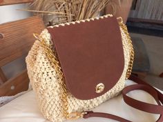 a brown and white purse sitting on top of a table