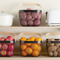 three baskets filled with fruit sitting on top of a shelf next to an air fryer