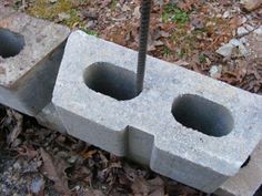 two concrete blocks with holes in them on the ground