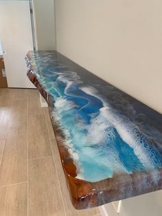 a bench that is sitting in the middle of a room with blue and white paint on it