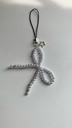 a cross made out of pearls on a string