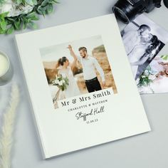 a wedding album with an image of a bride and groom on it next to flowers