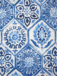 a blue and white rug with an intricate design on the front, in different colors