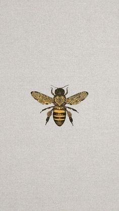 a close up of a bee on a white shirt with black and yellow details in the middle