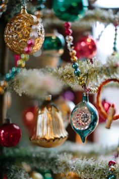 ornaments are hanging from the christmas tree