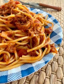 a plate full of spaghetti with meat and sauce