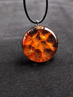 "Wooden resin sun pendant, glowing pendant, unique pendant, beachy jewelry, resin art jewelry, organic jewelry, gift for her, birthday gift \"Add a touch of celestial style to your jewelry collection with this handmade wooden resin sun pendant! The pendant features a unique sunburst design, with rays of warm woodgrain encased in a vibrant orange resin. Each pendant is carefully crafted by hand, making each one truly one-of-a-kind. The warm, earthy tones of the wood and the bright pop of color from the resin make this pendant the perfect statement piece for any boho or beachy outfit. It comes with a simple yet sturdy cord, making it easy to wear and style. This sun pendant is not only beautiful, but also eco-friendly, as it's made from natural materials. Add a touch of sunny charm to your d Resin Necklace As Gift, Round Resin Necklaces Perfect As Gifts, Orange Round Pendant Jewelry As Gift, Round Resin Necklaces Suitable For Gifts, Adjustable Resin Necklace As Gift, Personalized Brown Necklace For Gift, Orange Round Pendant Jewelry For Gift, Brown Resin Jewelry Gift, Brown Resin Jewelry For Gifts