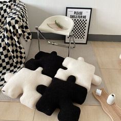 black and white rugs are on the floor in front of a chair, with other items nearby