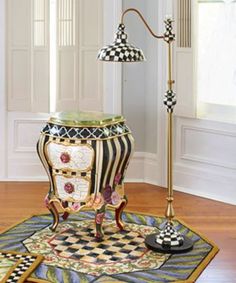 a lamp that is sitting on top of a rug in the middle of a room