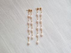 * Genuine 4 x 5.5 mm Freshwater Pearls (size may vary slightly) * 14K Gold Filled 4mm stud and materials * approx. 3.25 inches in length * Pearl shape: rice-shaped, potato-shaped * Hypoallergenic. Nickel, lead, and cadmium free materials Enhance your style with grace and charm. Our dangle earrings feature an elegant design that delicately hangs, adding a touch of sophistication and subtle allure to your look. Effortless elegance for any occasion. BASIC JEWELRY CARE: * Pearl and gemstone jewelry are NOT waterproof and should be removed prior to swimming, showering, and workouts. * Store your jewelry in an airtight container. * Clean jewelry with a jewelry cloth after each use. * Avoid sleeping in jewelry, which may cause jewelry to bend or even break. * Treating your jewelry with gentle car Earrings Pearl Drop, Clean Jewelry, Long Pearl Earrings, Pearl Earrings Wedding, Freshwater Pearl Earrings, Pearl Dangle Earrings, Basic Jewelry, Bridal Earrings Pearl, Freshwater Pearls Earrings