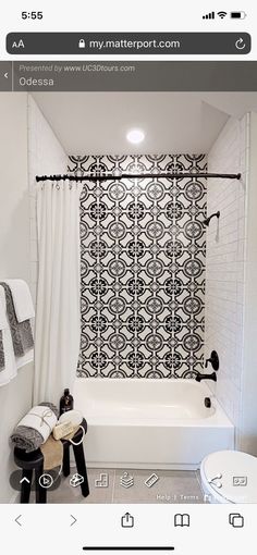 a white bathroom with black and white decor on the shower curtain next to the bathtub