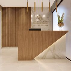 the front desk of an office with marble floors and walls, along with hanging planters