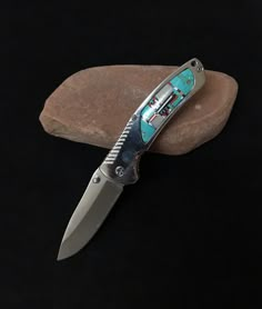 a knife is laying on top of a rock