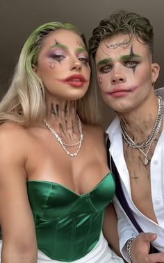 two people with makeup on their faces posing for the camera