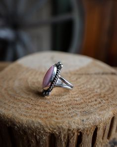 Pink Conch Slim Oval Ring- Size 7.5 Native American Material: Sterling Silver and Pink Conch Measurement: 1" (L) x .5" (W) Size: 7.5 Heirloom Oval Opal Ring With Polished Finish, Classic Jewelry With Large Oval Cabochon Stone, Classic Oval Cabochon Large Stone Jewelry, Untreated Oval Turquoise Ring, Oval Turquoise Ring With Polished Finish, Pink Ruby Ring In Sterling Silver, Vintage Dome Ring With Polished Finish, Vintage Polished Dome Ring, Oval Turquoise Ring For Wedding