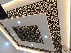 the ceiling is decorated with black and white geometric designs, along with recessed lighting