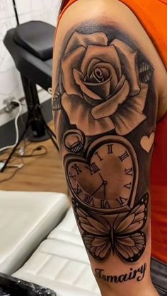 a woman's arm with a clock and rose tattoo on it, which reads finally