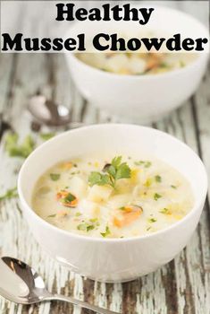 two white bowls filled with soup on top of a wooden table